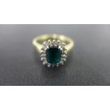 An emerald and diamond cluster ring - St