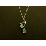 An opal and diamond pendant - Stamped 14