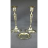 A pair of weighted silver candlesticks -