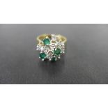 A 9ct gold emerald and diamond cluster r