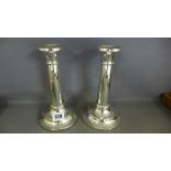 A pair of silver candlesticks with gun b