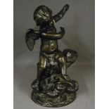A bronze figure of a cherub with a drago