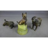 Three small bronze dog figures - one on