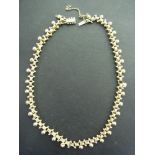 A fancy-link necklace - Tests as 9ct gol