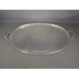 A large oval twin handled silver tray -