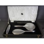 A boxed silver four piece dressing set -