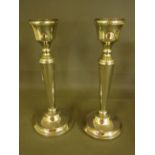 A pair of silver weighted candlesticks -