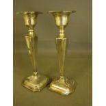 A pair of weighted silver candlesticks -