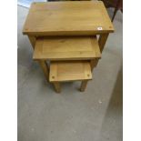 A set of three oak nest of tables