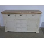 A new hardwood painted sideboard with a