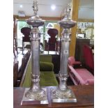 A pair of silver plated table lamps with