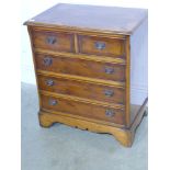 A modern yew veneer small chest of drawe