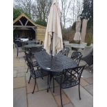 A Bramblecrest Ancona table with six chairs, a parasol and base - with cushions