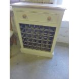 A painted 36 bottle wine rack with a dra