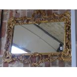 An ornate gilt mirror - 84 cm x 71 cm