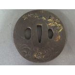 A Japanese iron Tsuba inlaid with bronze