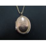 A 9ct gold oval locket - With monogram d