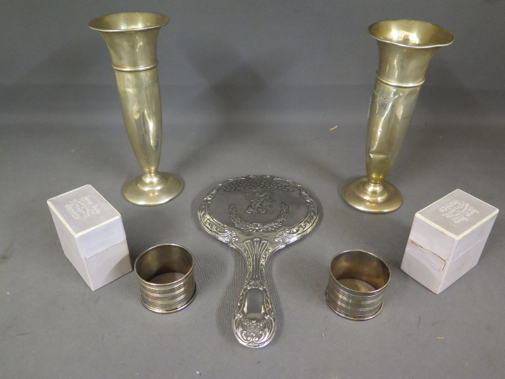 Two boxed silver napkin rings, a pair of