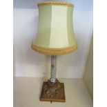 An ormolu mounted table lamp with a deco