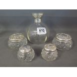 A collection of four silver and glass dr