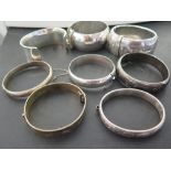 An assortment of seven bangles and a cuf