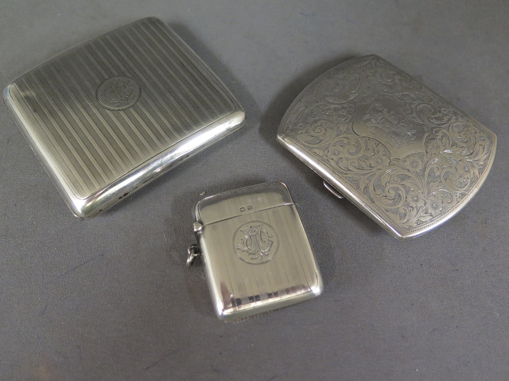 Two silver cigarette cases and a silver