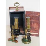 A two lacquered brass microscopes of the