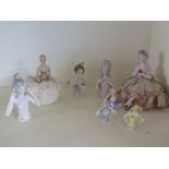 A collection of eight china lady pincush