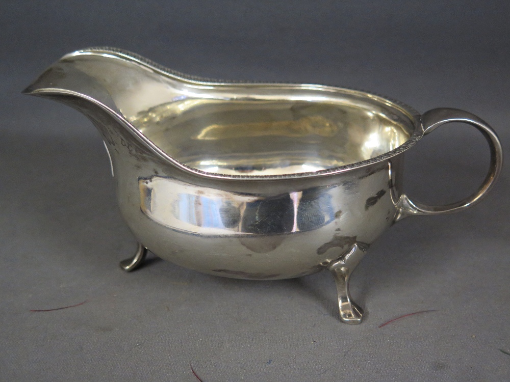 A silver sauce boat with egg and dart mo