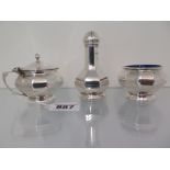 A silver three piece cruet set of facete