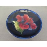 A small Moorcroft pin dish - Diameter 9 cm 
Condition report: Repaired chip to rim