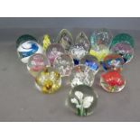 A selection of modern glass dump weights including two green glass with bubbles to interior on