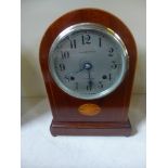 An eight day mahogany with inlay mahogany clock strikes hours/half on coiled gong 
Condition