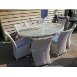 A Bramblecrest Sahara 212 cm x 150 cm white Elliptical table with eight white side chairs, a 3 m