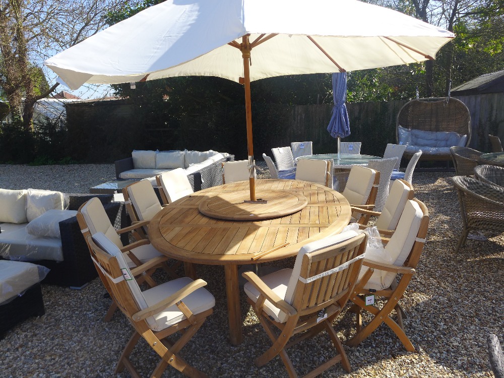 A Bramblecrest Oxford elliptical table with 100cm lazy susan, ten armchairs with cushions, parasol