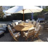 A Bramblecrest Oxford elliptical table with 100cm lazy susan, ten armchairs with cushions, parasol