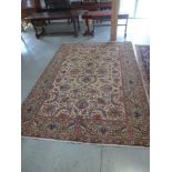 A large foliate design Tabriz rug on beige ground with geometric patterned borders within green