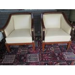 A pair of good quality leather armchairs on square tapering legs