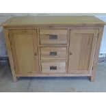 A Vancouver oak sideboard with three drawers and two cupboard doors - Height 95 cm x Width 1.37 m x