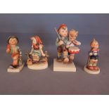 Four Goebel figures including drummer boy with escort, boy with umbrella and case, a girl sitting