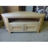 A modern oak TV stand with open compartments over two drawers
