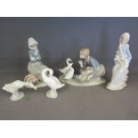 A group of five Lladro figures including girl holding flowers, girl feeding ducks, girl sitting