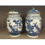 A near pair of large blue and white Oriental lidded jars, decorated with mythical birds - Height 33