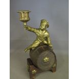 A brass bronze boy sitting on a wooden barrel candlestick - Height 24 cm