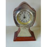 An Arts and Crafts clock with silver plated front plate - Height 21 cm