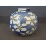 An Oriental ovoid form vase of blue and white ground with fine decoration highlighted with gilt,
