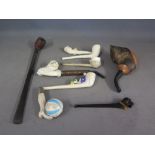 Two wooden pipes, six clay pipes and one plastic in a form of a dog