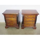 A pair of reproduction mahogany four drawer chests or bedside chests with Corinthian capitals