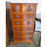 A serpentine fronted six drawer chest