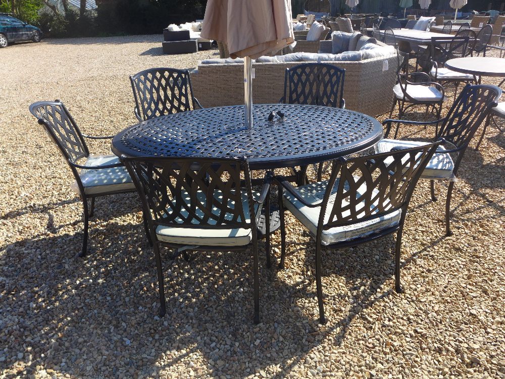 A Bramblecrest Rome elliptical table 167cm x 112cm with six stacking armchairs, seat pads and